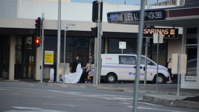 The police at the scene of the deceased body on the corner of Flinders St and Fletcher St.