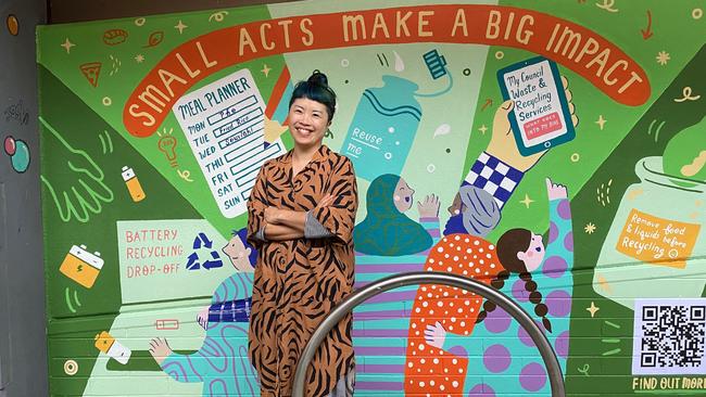 Melbourne artist Yan Yan Candy Ng in front of her recycling mural in Chancery Lane, Bendigo, which was unveiled on Oct 5, 22.