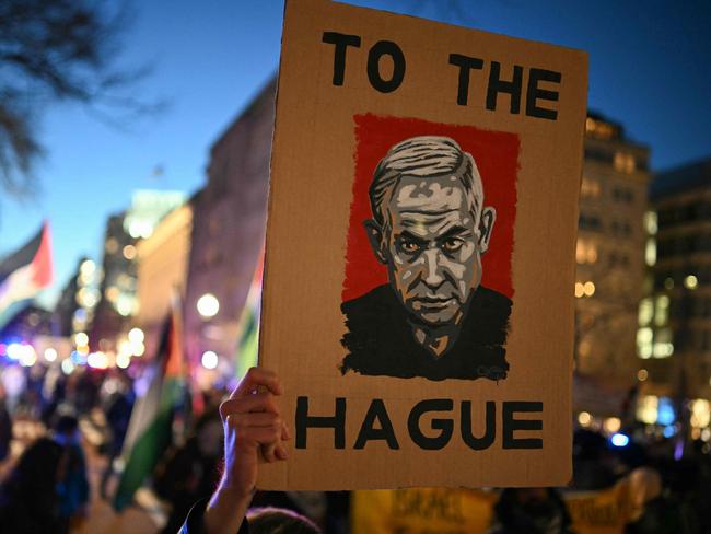 A protester holds up a poster with an image of Israeli Prime Minister Benjamin Netanyahu as they rally in support of Palestinians. Picture: AFP