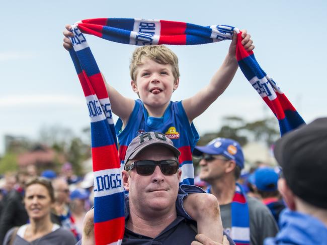 Six-year-old Hugh watches proceedings with his dad Shane. Picture: Eugene Hyland
