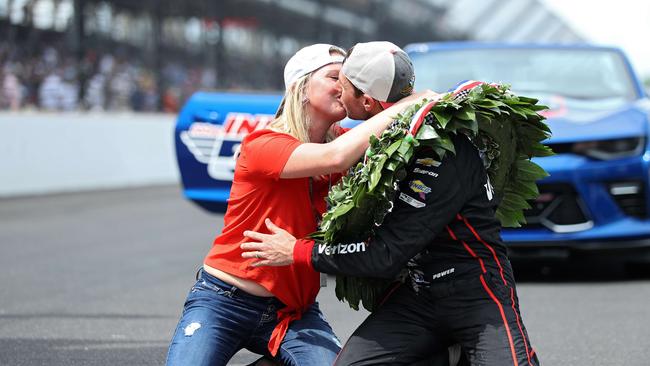 Will Power kisses his wife, Elizabeth Cannon. Picture: Getty images