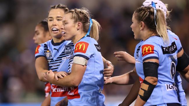 Emma Tonegato of the Blues celebrates a try.