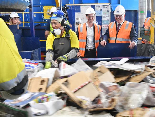 Assistant Minister for Waste Reduction and Environmental Management, Trevor Evans (centre) and Australian Prime Minister Scott Morrison (right) are seen during a tour of the Visy Recycling Facility in Brisbane last month. Around 60 per cent of Australian paper and cardboard is recycled. Picture: AAP Image/Darren England via NCA NewsWire