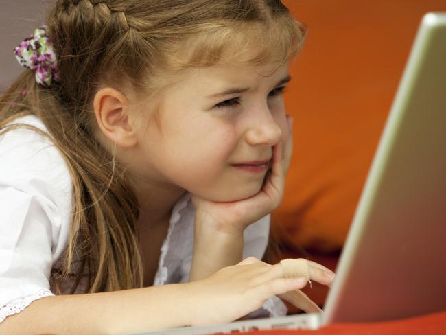 Undated : Injuries from computer use at home ... generic pic - young girl lying down using a laptop computer