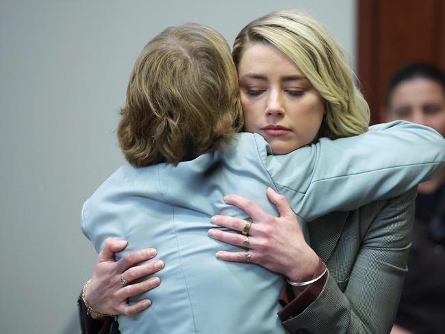 Amber Heard hugs her lawyer Elaine Bredehoft. Picture: AFP