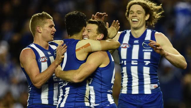 Brent Harvey celebrates his goal with (from left) Jed Anderson, Lindsay Thomas and Ben Brown.