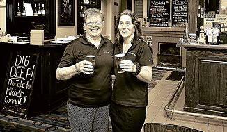 CHEERS! Current Empire Hotel owner Lyn Sutton with bar attendant Julie Bedford. Picture: Contributed