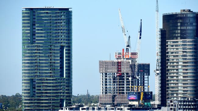 The Opal Tower (left) is seen at Sydney Olympic Park in Sydney, Monday, December 25, 2018. More than 200 people have been evacuated from a 36-story high-rise building amid fears the structure could collapse. Emergency services were called to the Opal Tower on Monday afternoon following reports residents of the building had heard cracking sounds throughout the morning. (AAP Image/Dylan Coker) NO ARCHIVING