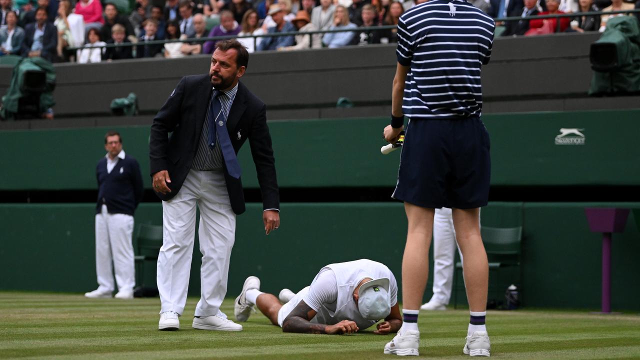 Nick Kyrgios goes down after slipping. (Photo by Shaun Botterill/Getty Images)