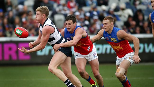 Former Lion Tom Rockliff (centre) is set for a midfield battle with Mitch Robinson (right) when Brisbane hosts Port Adelaide at the Gabba. 