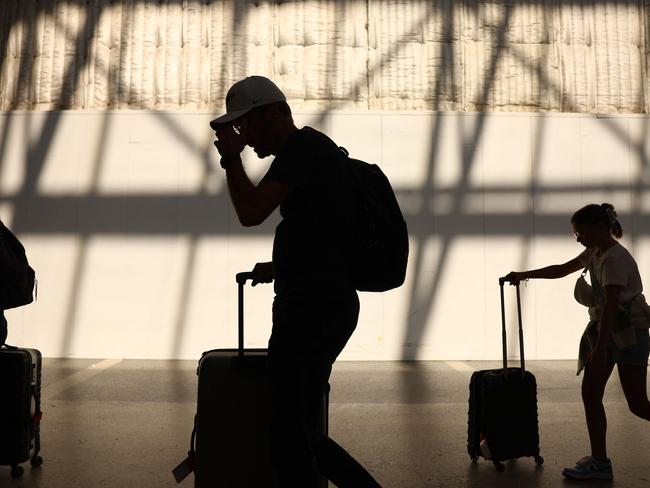 LOS ANGELES, CALIFORNIA - AUGUST 31: Travelers walk with their luggage in the international terminal at Los Angeles International Airport (LAX) on August 31, 2023 in Los Angeles, California. Labor Day weekend will cap off the busiest summer of airline travel on record in the U.S. with over 14 million passengers predicted to board flights, which will top pre-pandemic travel numbers. According to the FAA, today will be the busiest day of the holiday weekend with 52,203 flights scheduled in U.S. airspace.   Mario Tama/Getty Images/AFP (Photo by MARIO TAMA / GETTY IMAGES NORTH AMERICA / Getty Images via AFP)