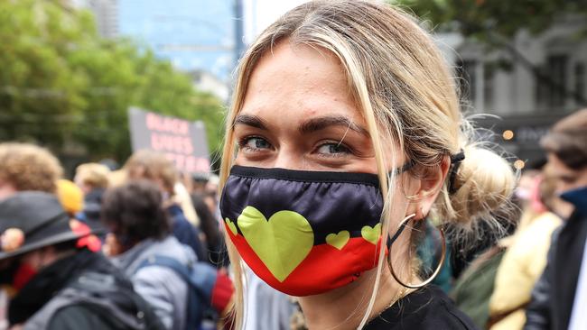 A masked woman during the Invasion Day Rally Picture: NCA NewsWire / Ian Currie