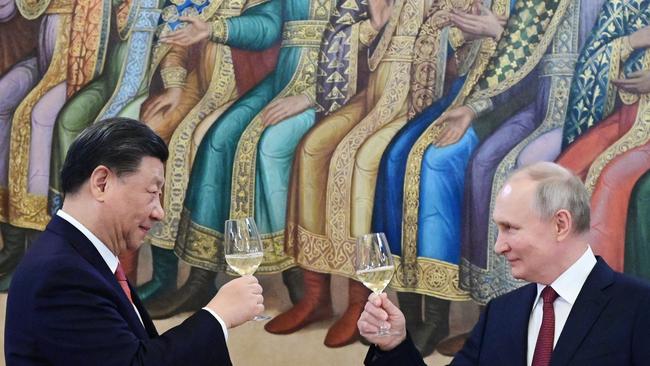 Russian President Vladimir Putin and China’s President Xi Jinping make a toast during a reception following their talks at the Kremlin.