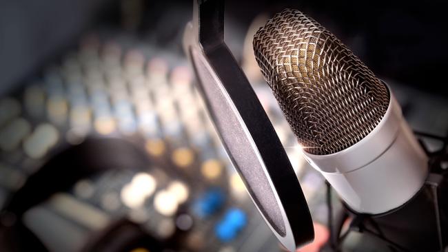 Recording equipment in studio. Studio microphone with headphones and mixer background. Elevated view