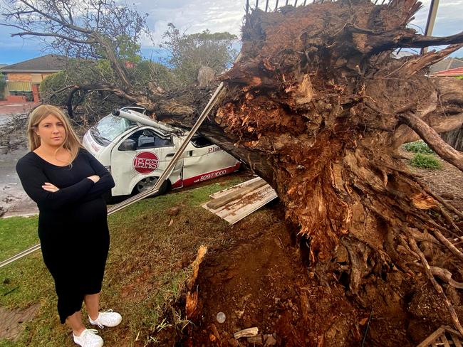 Kristen Stevens with cars that were struck by a fallen tree on Mitchell Street in Glengowrie. Picture: Michael Marschall