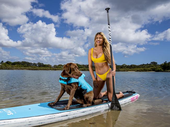 Lifeguard and stand-up paddleboarder Liv Hall and her dog Kona at Currumbin Creek. Picture: Jerad Williams