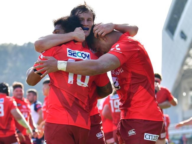 (l-r) Garth April, James Dargaville and Siosaia Fifita of the Sunwolves celebrate their opening round win over Melbourne Rebels. Picture: Getty Images