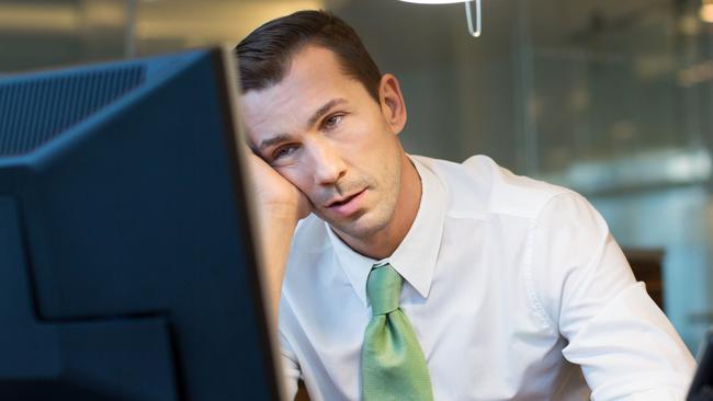 Exhausted businessman working overtime in the office