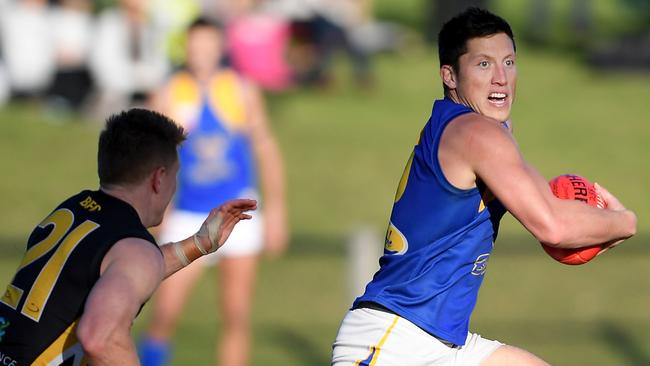 Noblem Park’s Jackson Sketcher runs away from Balwyn’s Tom Wilson.