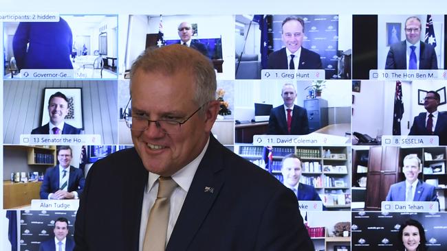 Prime Minister Scott Morrison poses for photographs with newly sworn-in government ministers at the end of a virtual swearing-in ceremony at Government House on December 22.