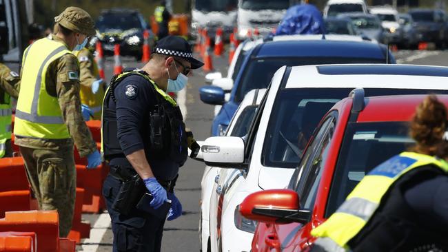 Police and ADF stop vehicles travelling out of Melbourne at the police checkpoint near Little River in Melbourne in 2020. Picture: Daniel Pockett