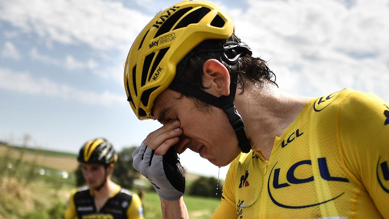 Great Britain's Geraint Thomas cleans his stinging eyes after tear gas was used during a farmers' protest who attempted to block the stage's route, during the 16th stage of the 105th edition of the Tour de France.