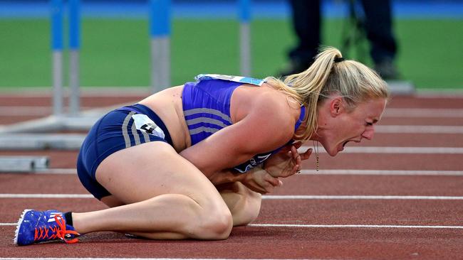 Sally Pearson shouts in pain after hitting an obstacle during the women's 100 hurdles event, at the Golden Gala IAAF athletic meeting, in Rome's Olympic stadium, Thursday, June 4, 2015. Olympic champion Sally Pearson of Australia was injured after hitting the fifth obstacle in the 100 hurdles. She was carried off on a stretcher after getting attention to her left wrist area. (Alessandro Di Meo/ANSA via AP)