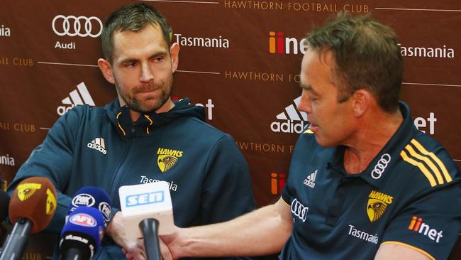 Luke Hodge shakes hands with Hawks coach Alastair Clarkson after announcing his retirement on the eve of his 300th game. Pic: Getty Images