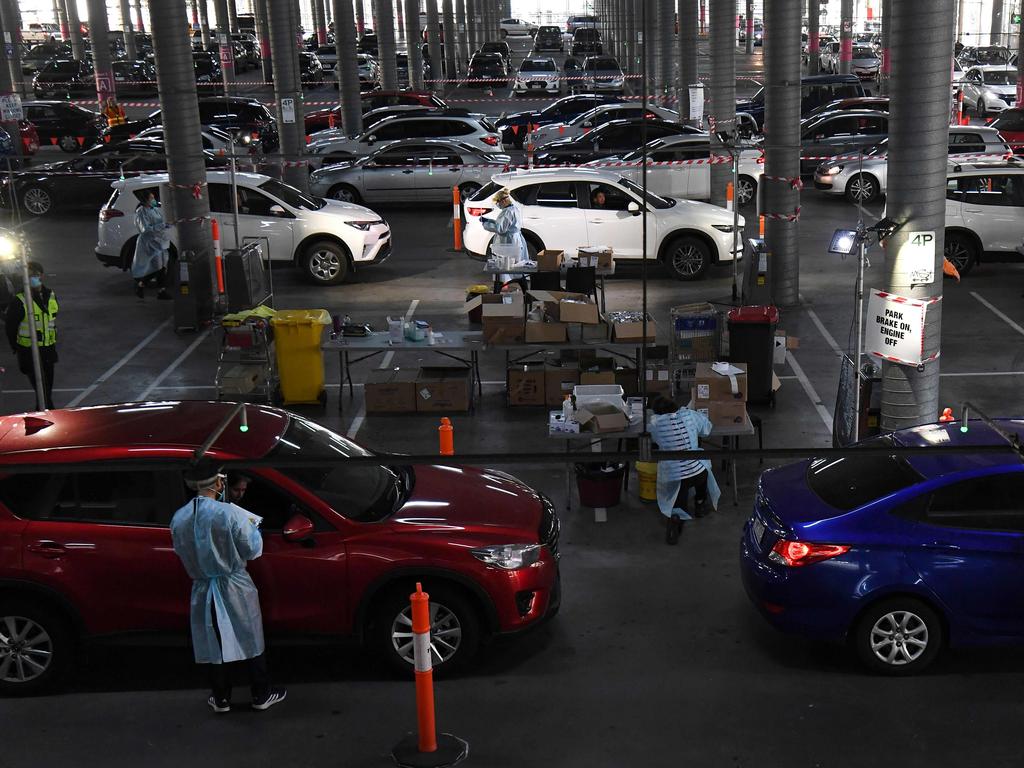 Medical workers staff a drive-through COVID-19 testing site located in a shopping centre carpark in Melbourne on Tuesday. Picture: William West