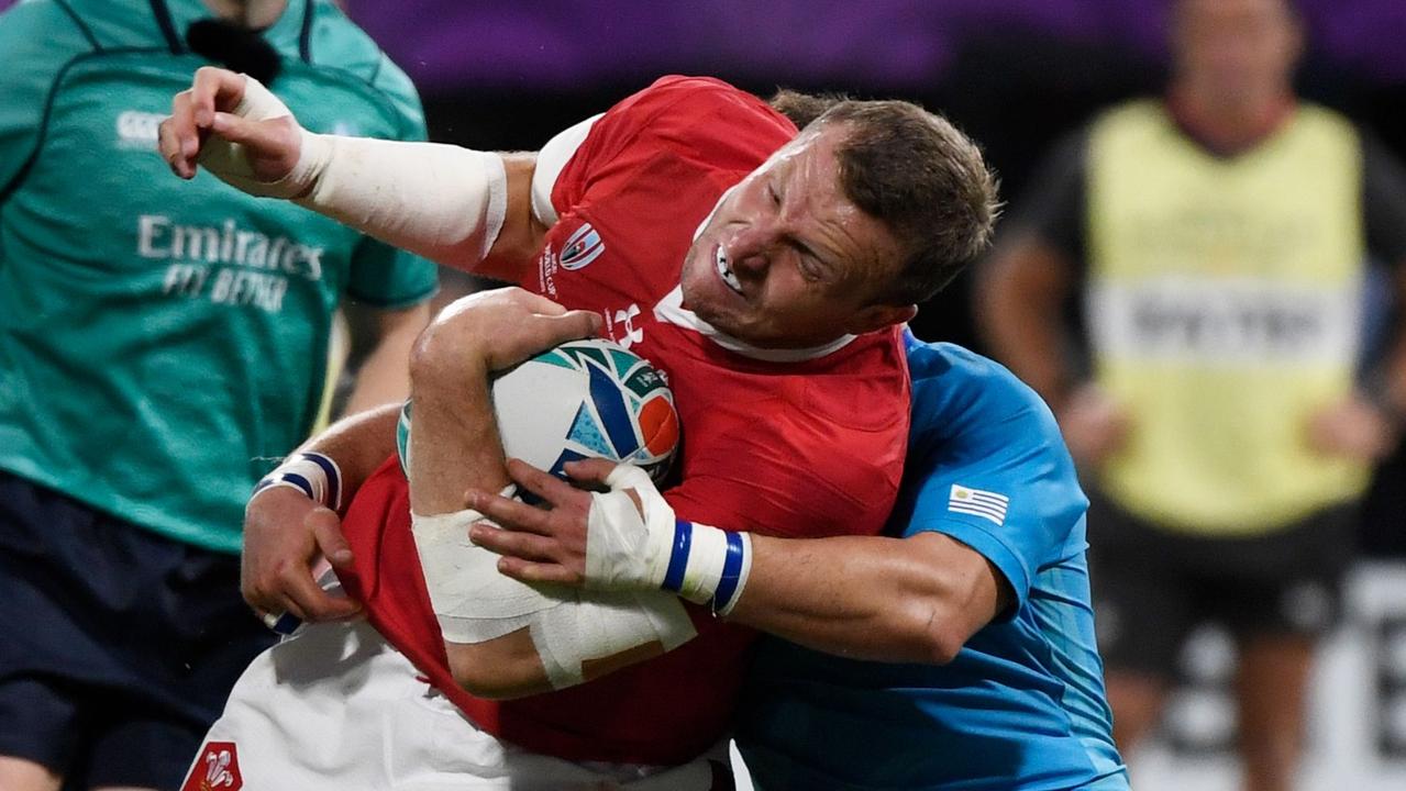 Wales centre Hadleigh Parkes is tackled at the Kumamoto Stadium.