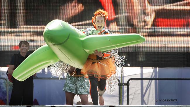 Emma “Memma” Watkins leaps off the stage as part of the annual Moomba Birdman rally. Picture: Tony Gough