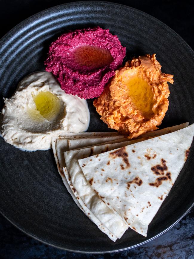 Hummus, beetroot and carrot dips with olive oil and pita bread. Pictures: Monique Harmer