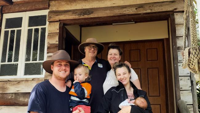 Steve and Sonia Ellery with Kurt and Tahlia Harlow, holding sons Billy and Jack, outside the entrance to Hidden Valley Cabins. Photo: Facebook