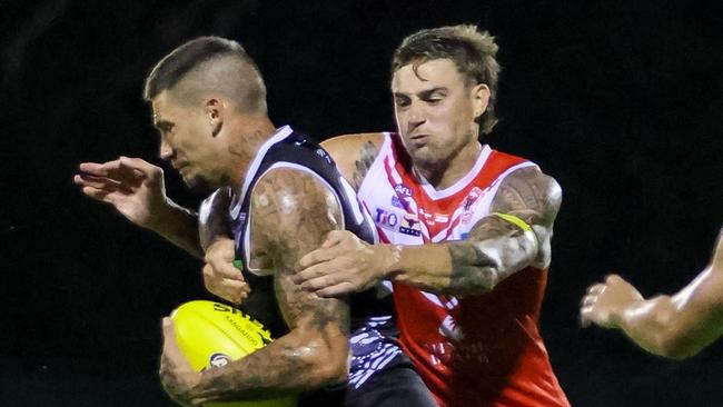 Jayden Magro of Waratah tackles Palmerston Magpies recruit Josiah Farrer in round 4 of the 2022-23 NTFL season. Picture: Celina Whan / AFLNT Media