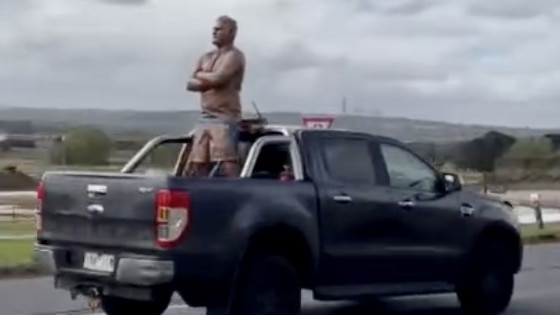 The 'brass Fev', a statue of Brendan Fevola, is seen on the back of a ute heading to the city. Picture: Supplied