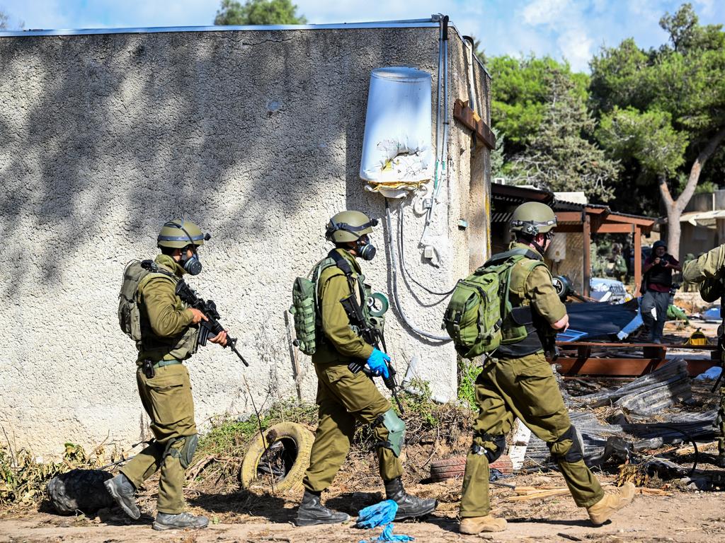 IDF soldiers move through neighbourhoods destroyed by Hamas militants. (Photo by Alexi J. Rosenfeld/Getty Images)