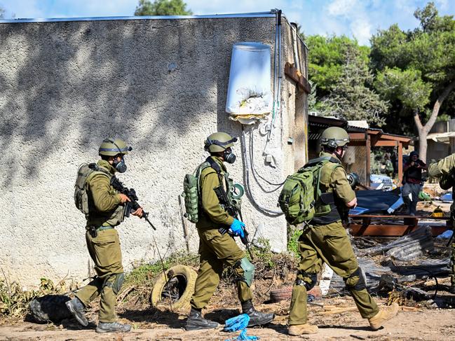 IDF soldiers move through neighbourhoods destroyed by Hamas militants. (Photo by Alexi J. Rosenfeld/Getty Images)