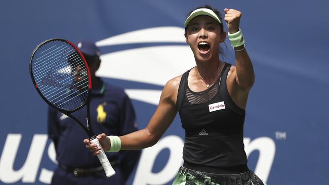 Qiang Wang reacts after defeating Ashleigh Barty.