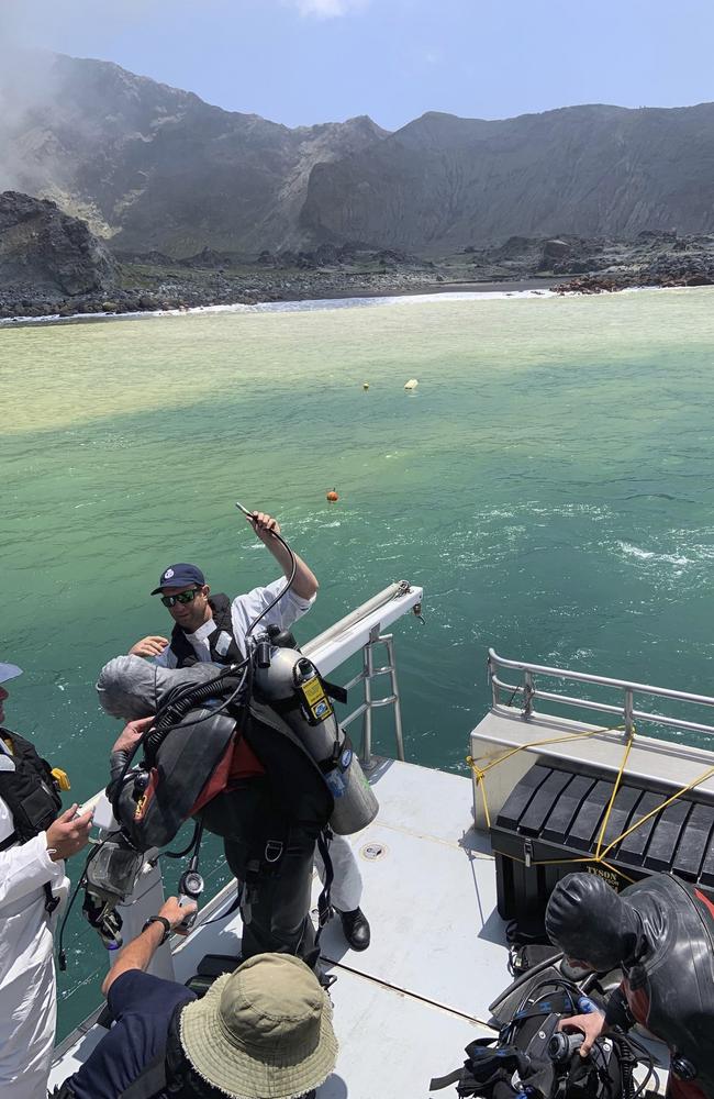 Police divers prepare to search the waters near White Island off the coast of Whakatane, New Zealand. Picture: AP