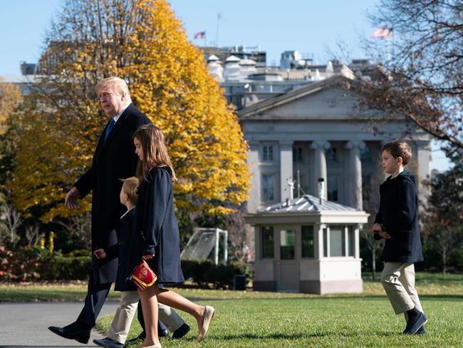 US President Donald Trump, followed by his grandchildren Arabella, Theodore, and Joseph./ Picture: AFP