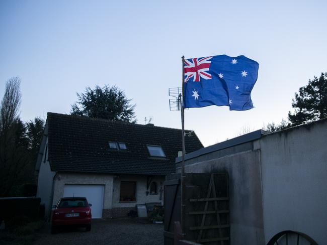 An Australian flag flies out the front of a house in the town of Villers-Bretonneux. Picture: Marie Genel