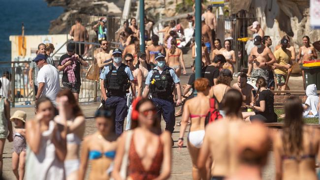 Police patrol among crowds at a packed Bronte Beach in Sydney on Saturday. Picture: Julian Andrews