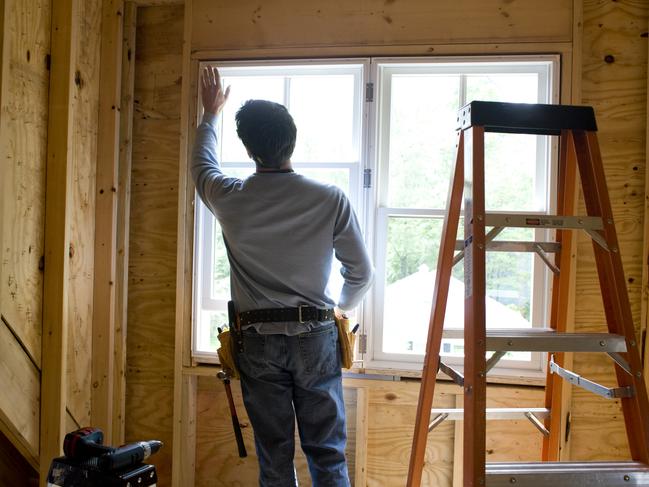 Courier-Mail, Home, Master Builders feature - November - generic Master builders piece.Contractor working on window in new home