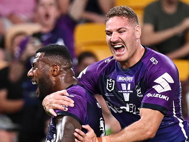 BRISBANE, AUSTRALIA - OCTOBER 16: Suliasi Vunivalu and Brenko Lee of the Storm celebrate Dale Finucane of the Storm scoring a try during the NRL Preliminary Final match between the Melbourne Storm and the Canberra Raiders at Suncorp Stadium on October 16, 2020 in Brisbane, Australia. (Photo by Bradley Kanaris/Getty Images)