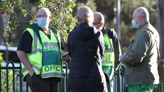 Police and medical staff outside the locked down apartments. Picture: David Crosling