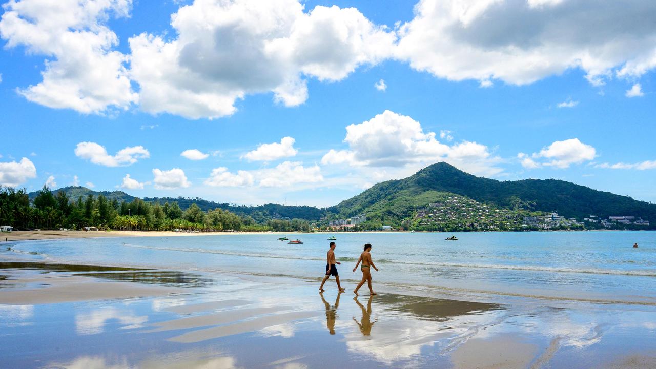 Tourists walk on a beach on the Thai island of Phuket. Picture: AFP