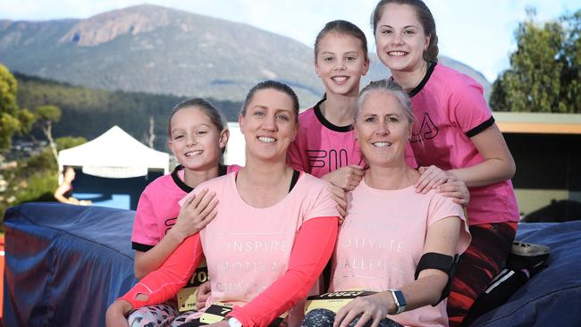 Friends Veronica Stubbs (left) and Annie Walker with their children (L-R) Mollie Stubbs, 10, Didi Walker, 10, and Millie Walker, 13, at the 2019 Mother's Day Classic on the Domain. Picture: LUKE BOWDEN