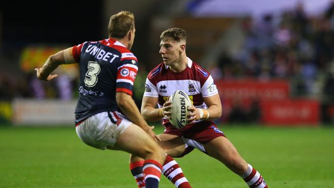 Wigan’s George Williams tries to get back Mitchell Aubusson during the first half. Picture: Getty