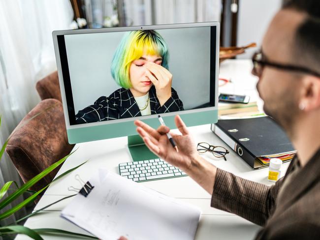 Male psychiatrist in online therapy session with his anxious patient