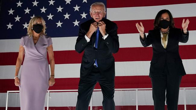 Joe Biden, flanked by wife Jill and running mate Kamala Harris, lets slip the mask in Wilmington, Delaware, at the conclusion of the convention. Picture: AFP